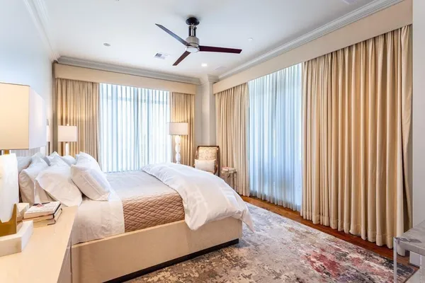 a bedroom with bed and a large window
