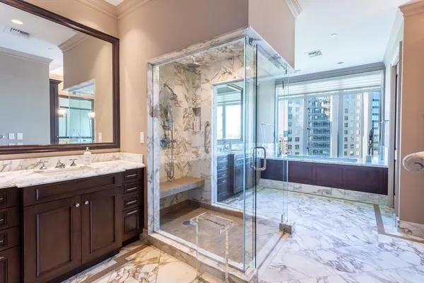 a spacious bathroom with a granite countertop tub sink and shower