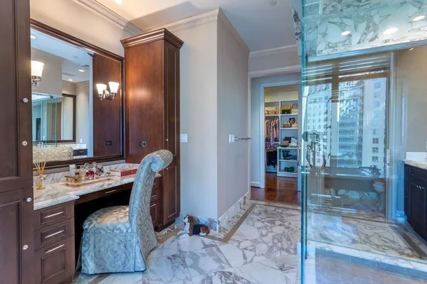 a spacious bathroom with a tub sink and mirror