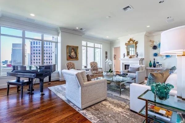 a living room with furniture fireplace and a table