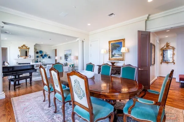 a dining room with furniture and wooden floor