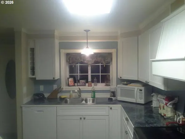 a hallway with a large mirror and a sink