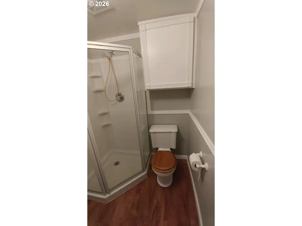 a bathroom with a sink shower and a mirror