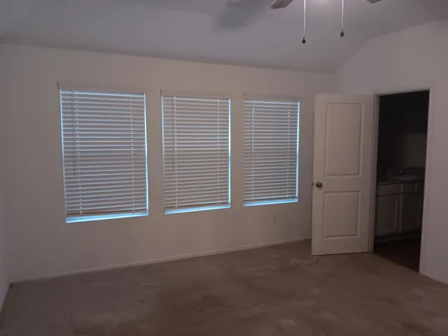 a view of an empty room with a window