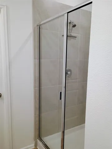 a bathroom with a glass shower door
