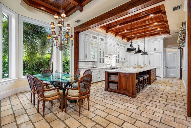 a view of a dining room with furniture a chandelier and wooden floor