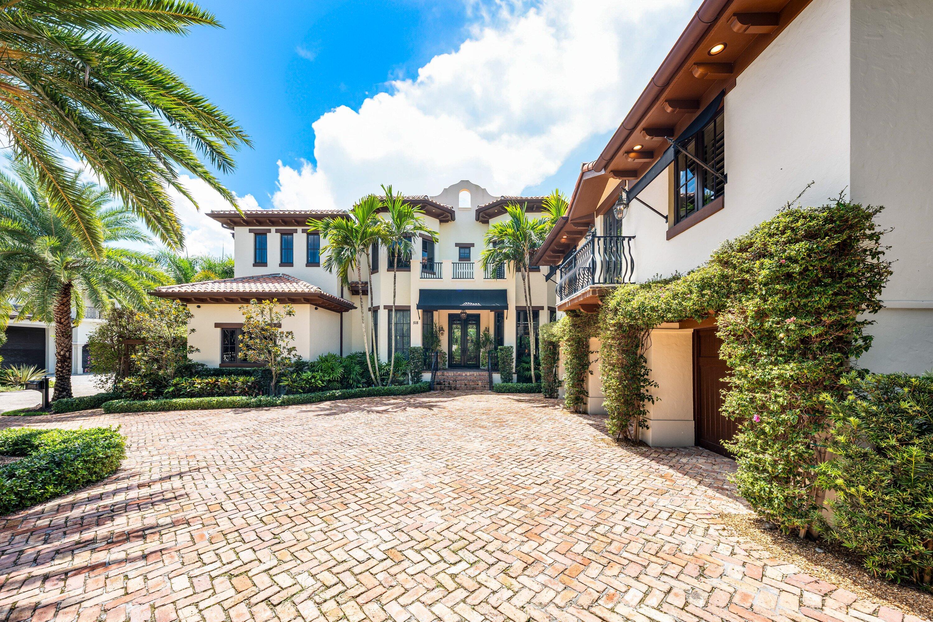 518 Harbor Court Delray Beach, FL 33483 - Photo 2 of 83 a front view of a building with a garden