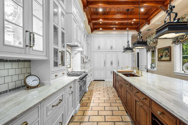 a bedroom with a large bed and a chandelier