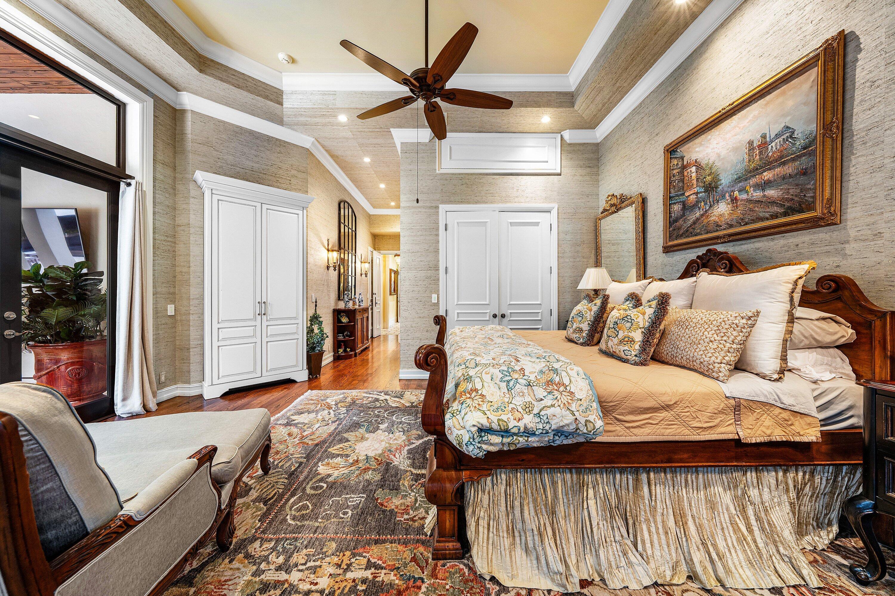 518 Harbor Court Delray Beach, FL 33483 - Photo 30 of 83 a bedroom with a large bed and a chandelier