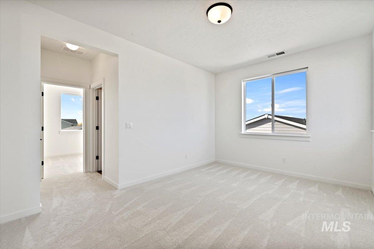 14701 Port Royal Street Caldwell, ID 83607 - Photo 25 of 40 Empty room featuring light carpet and baseboards