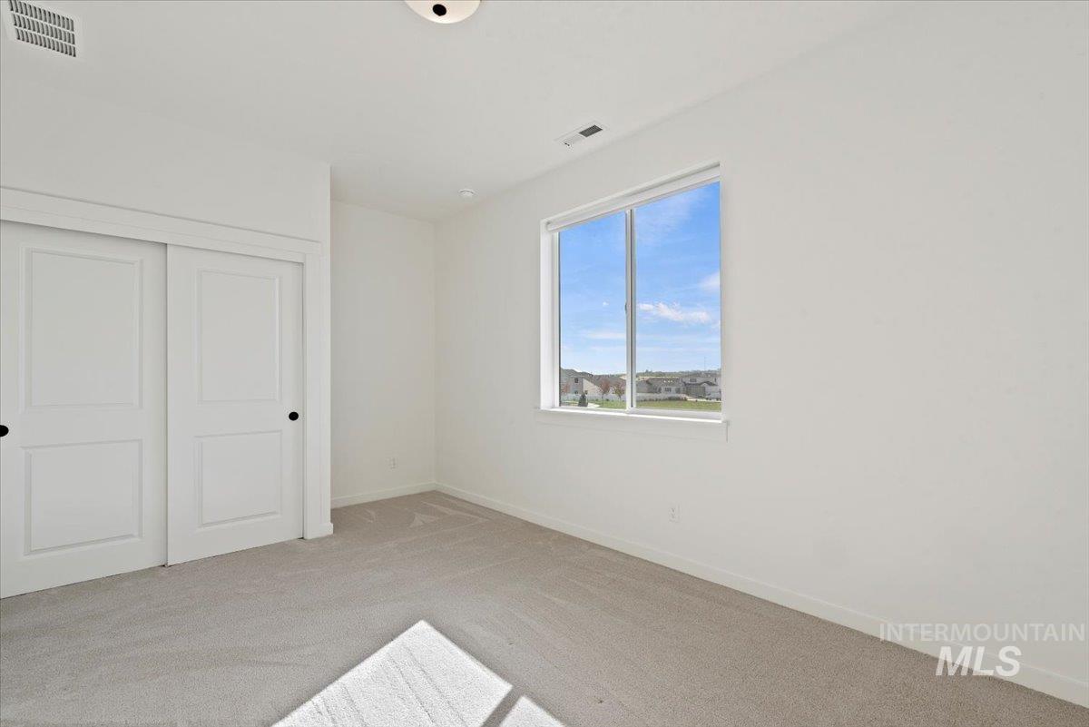 14701 Port Royal Street Caldwell, ID 83607 - Photo 26 of 40 Unfurnished bedroom featuring light colored carpet and a closet