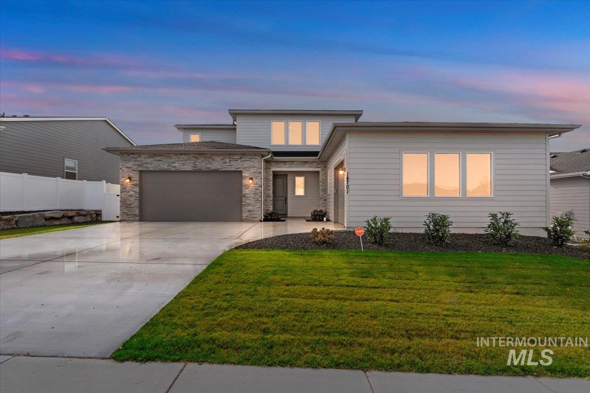 14701 Port Royal Street Caldwell, ID 83607 - Photo 3 of 40 View of front of house with concrete driveway and a garage