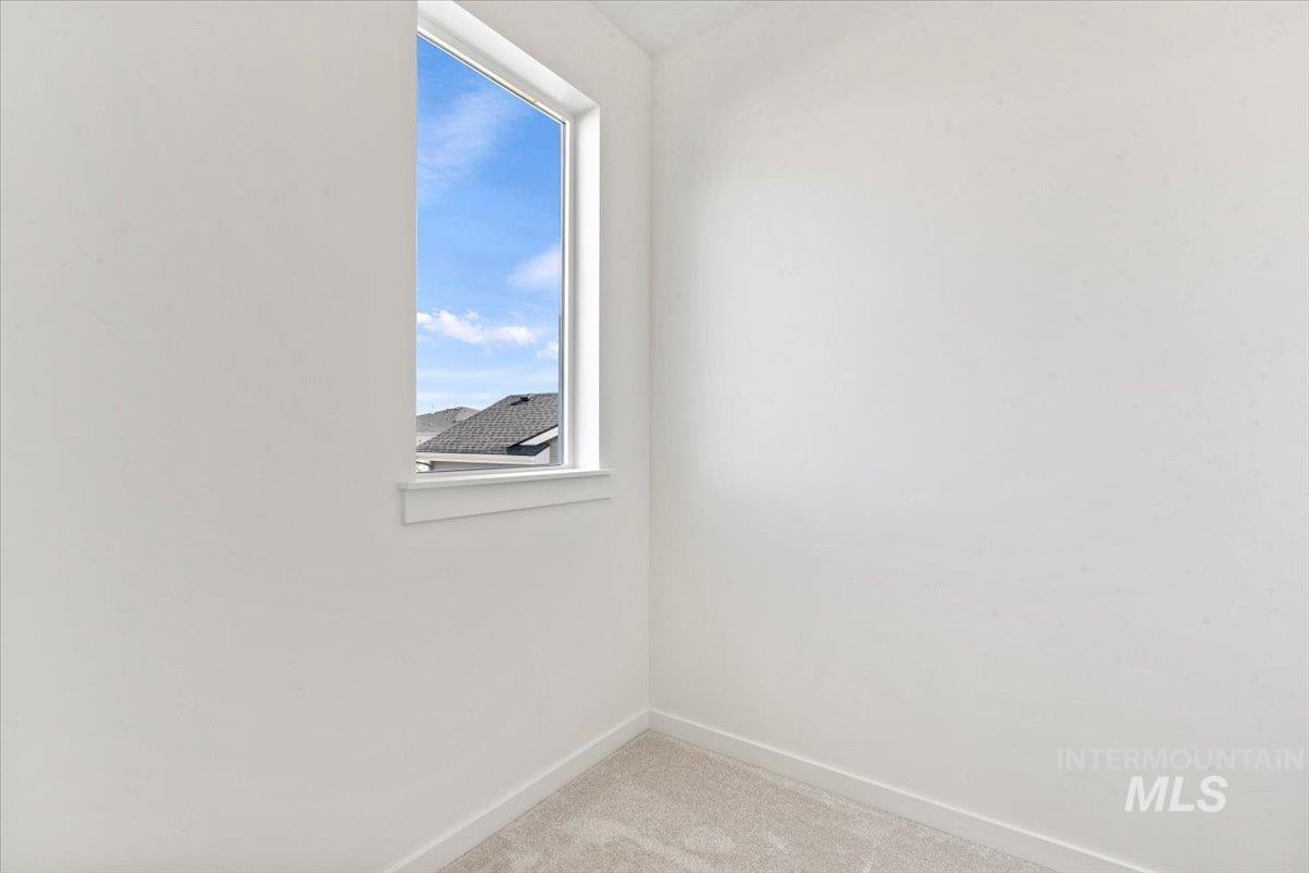 14701 Port Royal Street Caldwell, ID 83607 - Photo 31 of 40 Empty room featuring light carpet and baseboards