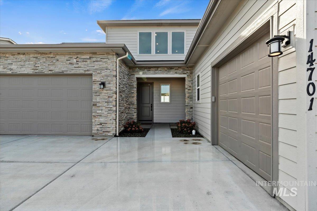 14701 Port Royal Street Caldwell, ID 83607 - Photo 4 of 40 Property entrance featuring stone siding and driveway