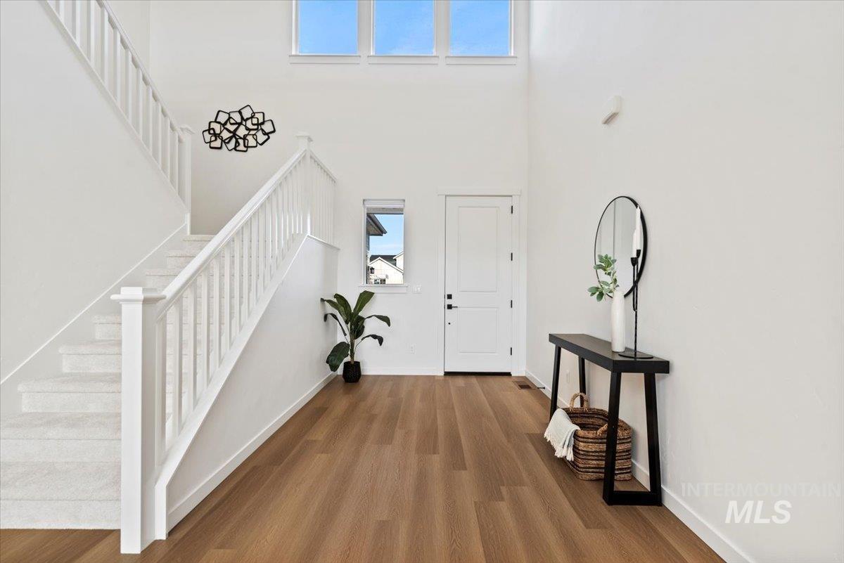 14701 Port Royal Street Caldwell, ID 83607 - Photo 5 of 40 Foyer with wood finished floors, stairs, and a towering ceiling