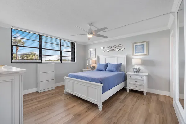 a bedroom with a bed and a large window