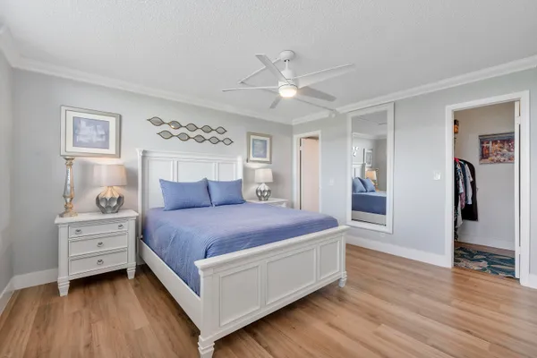 a spacious bedroom with a bed and a desk