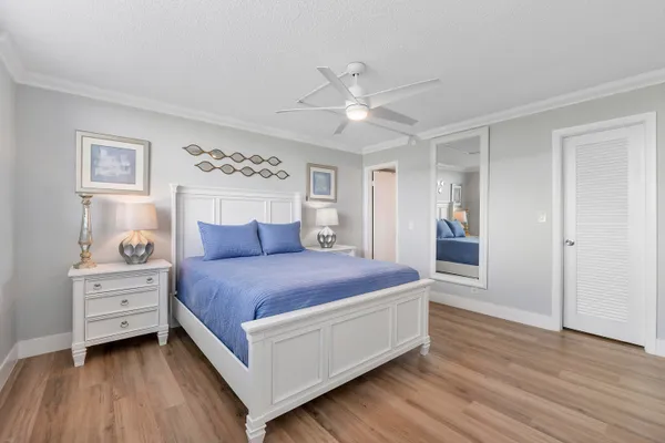 a spacious bedroom with a bed and a table