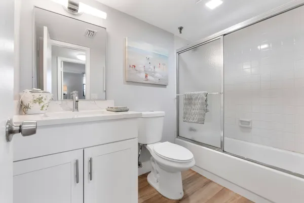 a bathroom with a toilet sink and shower