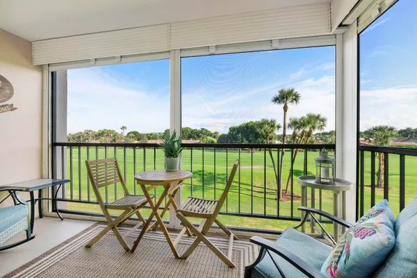 a view of a balcony with chairs and a table