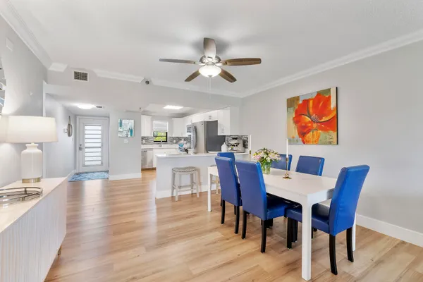 a view of a dining room with furniture and wooden floor