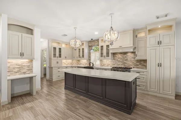 a kitchen with stainless steel appliances a stove a sink dishwasher and cabinets with wooden floor