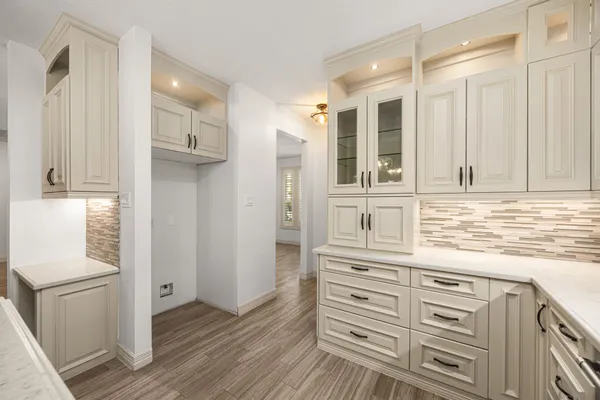 a kitchen with cabinets and wooden floor