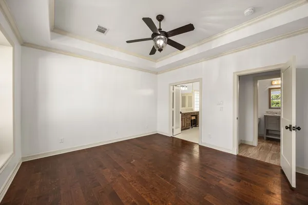 a spacious bathroom with a granite countertop sink a toilet a mirror and shower