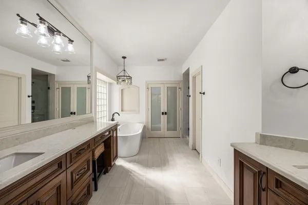 a spacious bathroom with a bathtub and shower