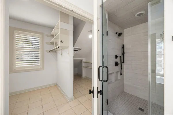a spacious bathroom with a double vanity sink a mirror and a bathtub