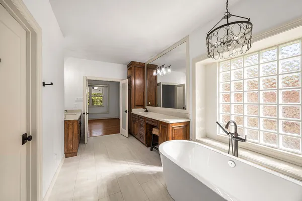 a spacious bathroom with a double vanity sink and a mirror