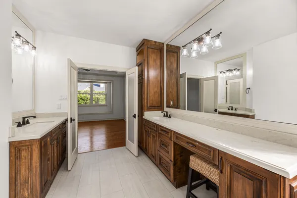 a view of a kitchen with white cabinets and refrigerator