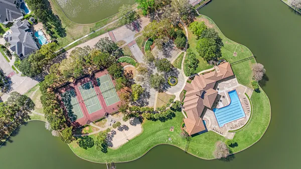 an aerial view of a house with outdoor space and lake view
