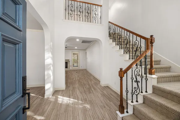 a view of entryway and hall with wooden floor