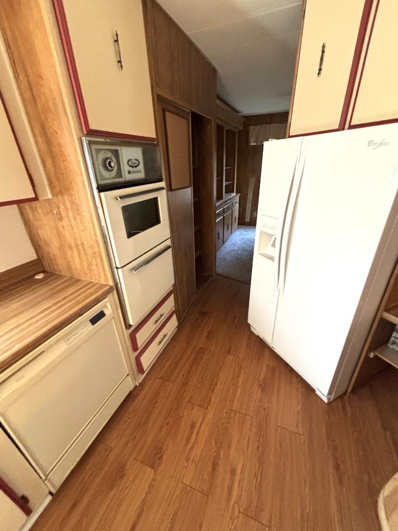 3156 Esplanade, Unit 304 Chico, CA 95973 - Photo 19 of 30 a view of a kitchen with wooden floor and electronic appliances