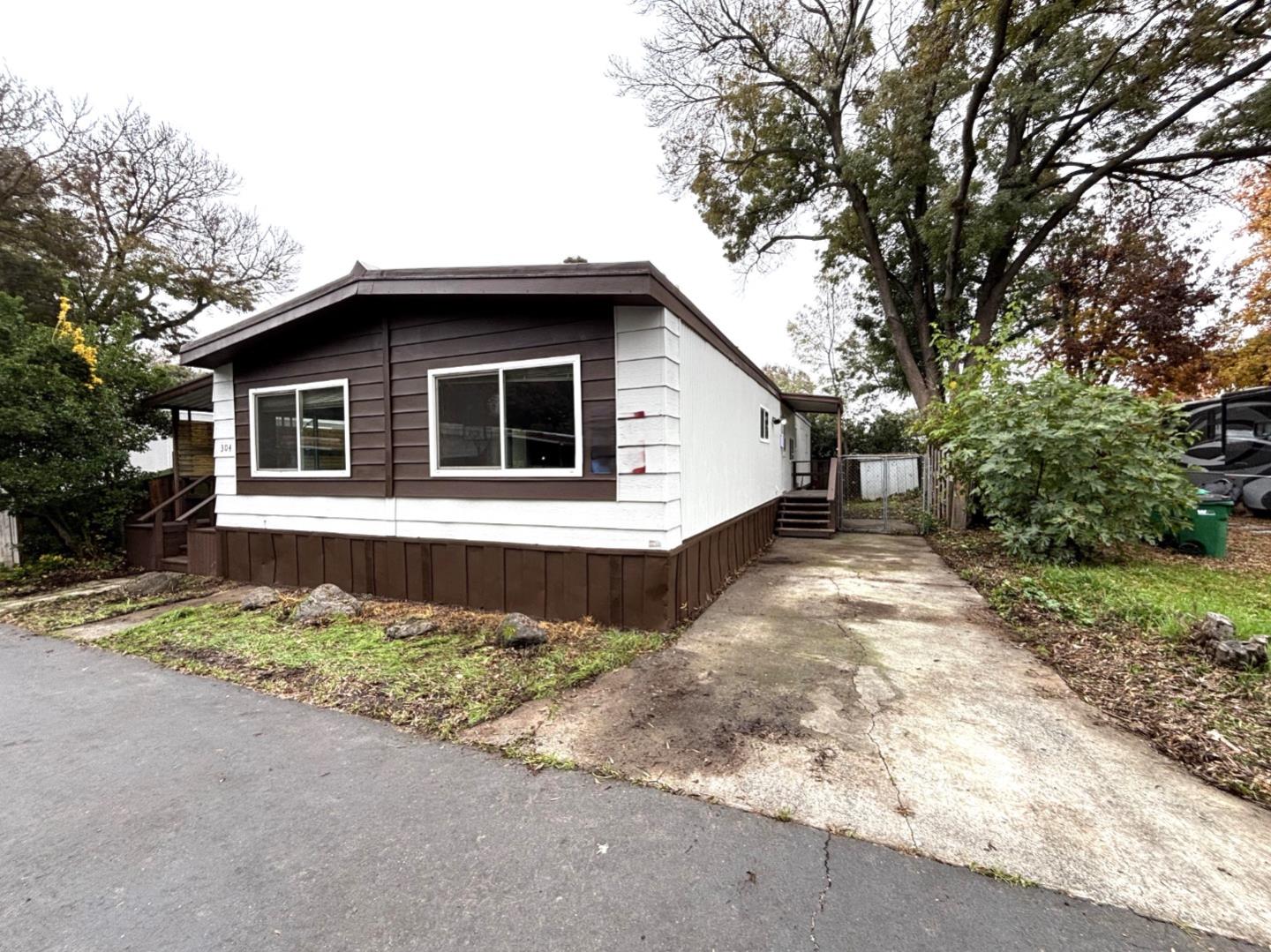 3156 Esplanade, Unit 304 Chico, CA 95973 - Photo 2 of 30 a front view of a house with a yard
