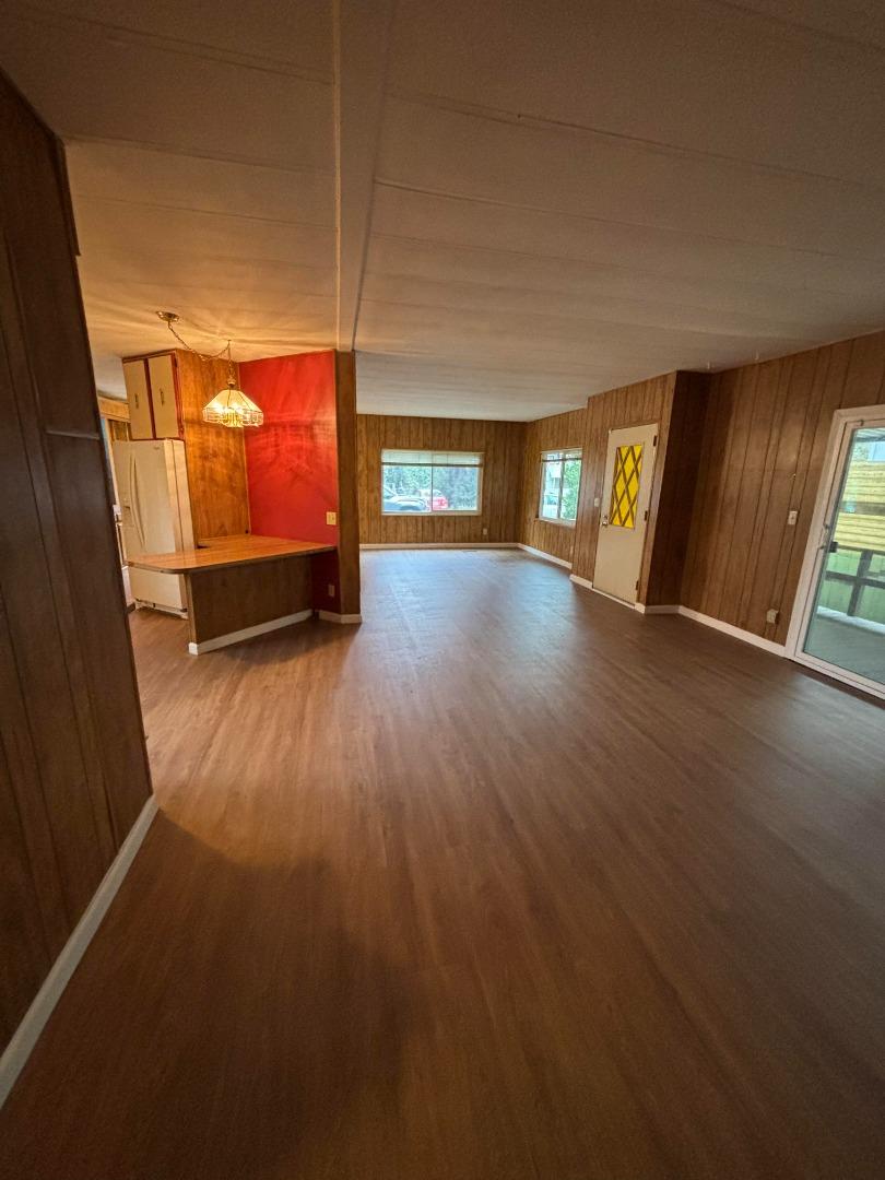 3156 Esplanade, Unit 304 Chico, CA 95973 - Photo 26 of 30 a view of an empty room with wooden floor and windows