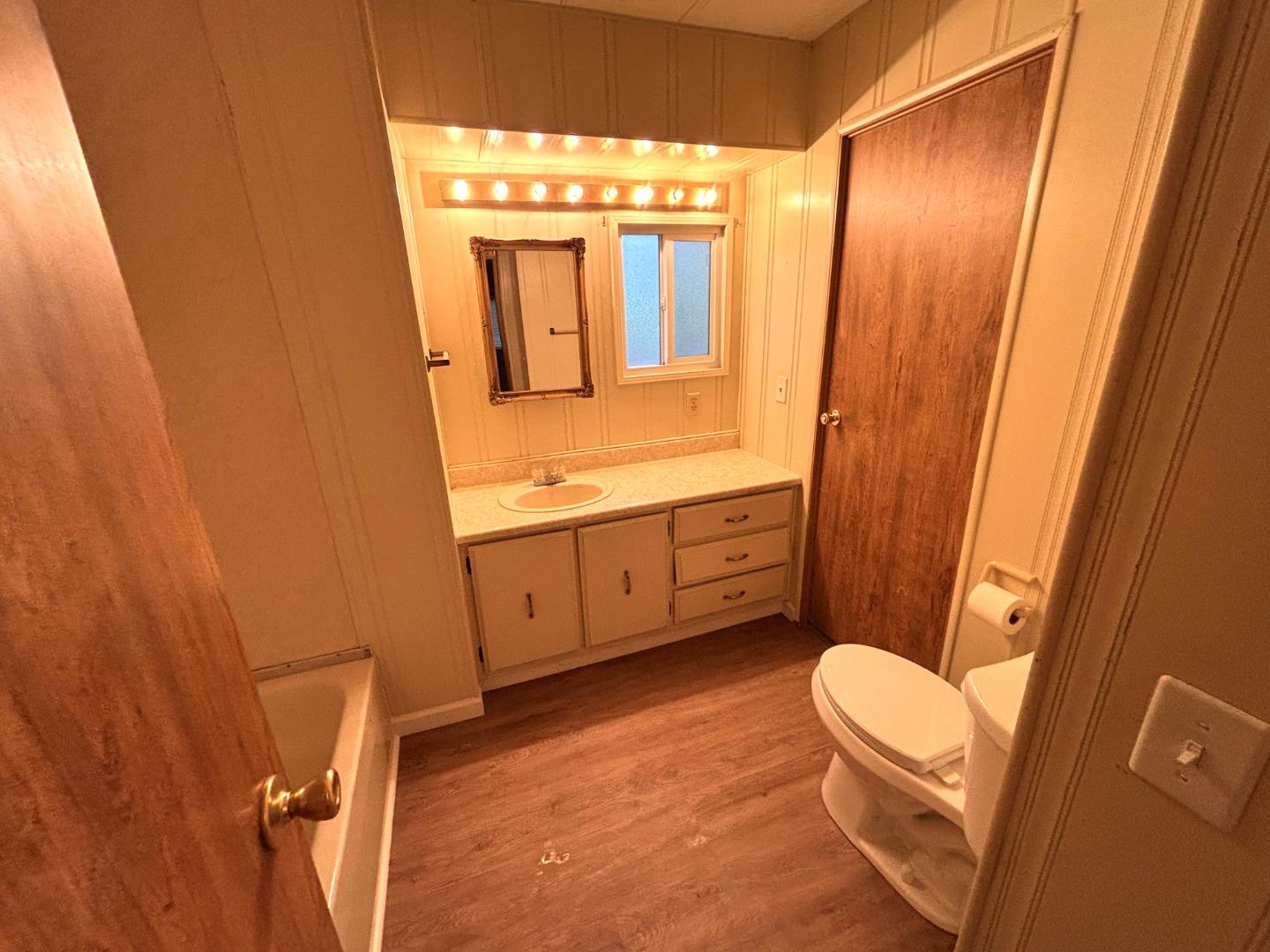 3156 Esplanade, Unit 304 Chico, CA 95973 - Photo 3 of 30 a bathroom with a toilet sink and mirror