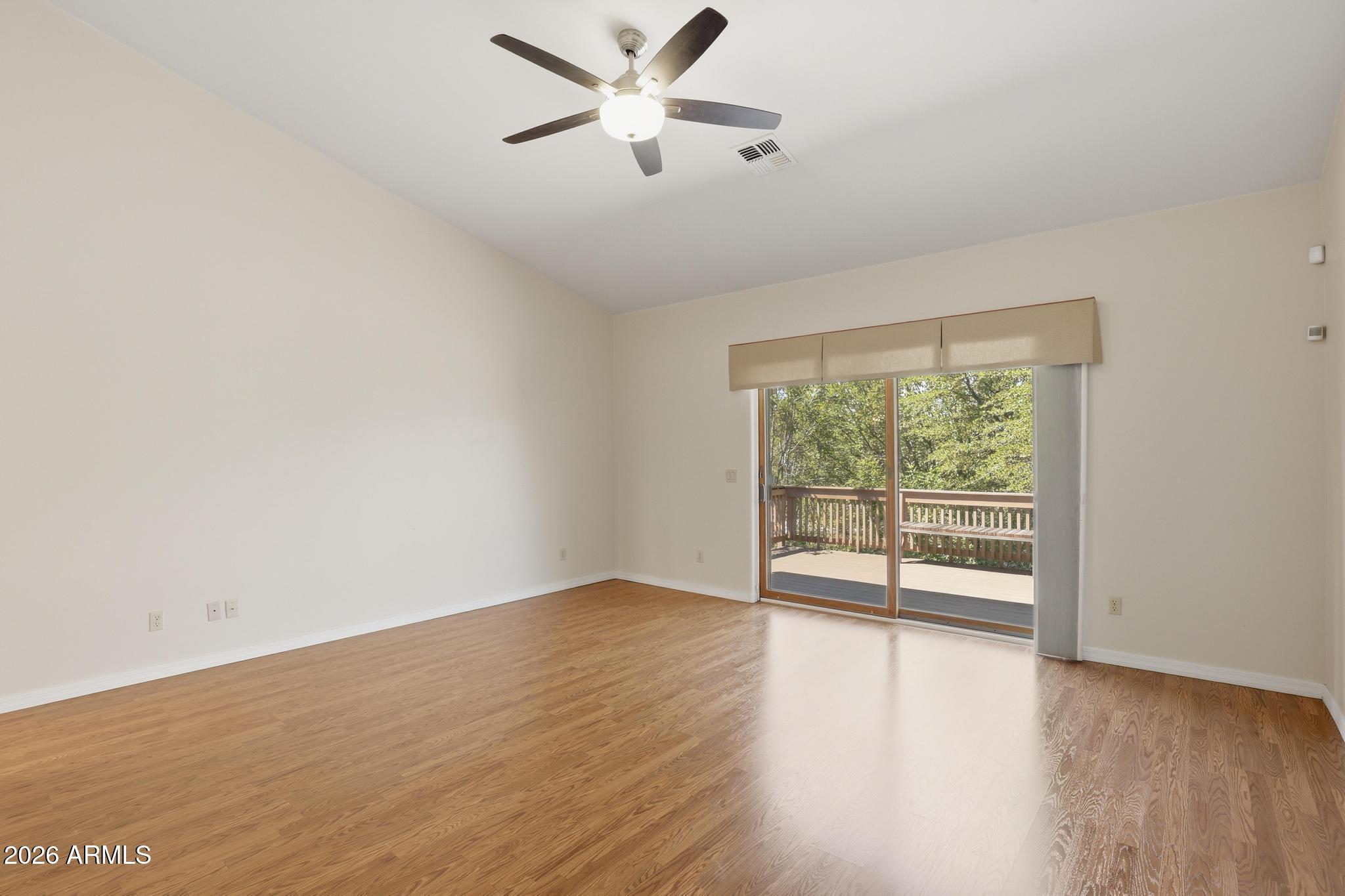 408 East Phoenix Street Payson, AZ 85541 - Photo 18 of 35 an empty room with wooden floor fan and windows