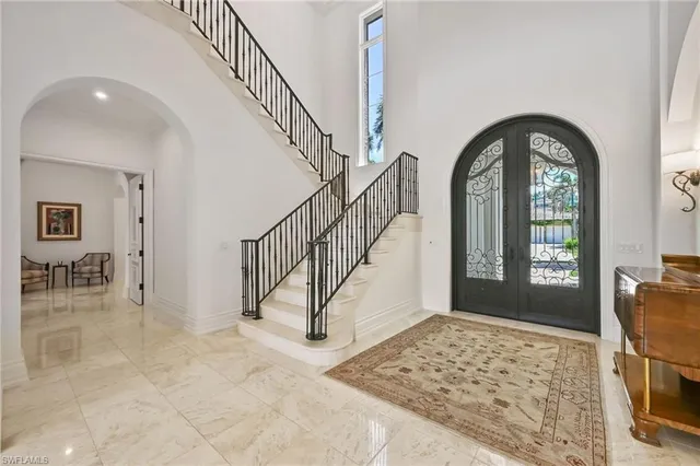 a living room with furniture chandelier and a large window