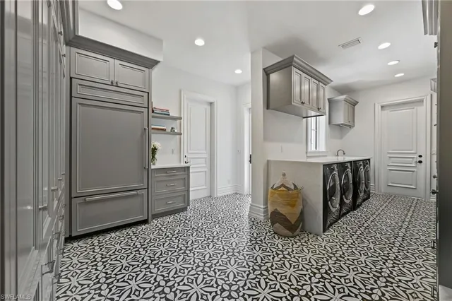 a kitchen with stainless steel appliances granite countertop a refrigerator and a sink