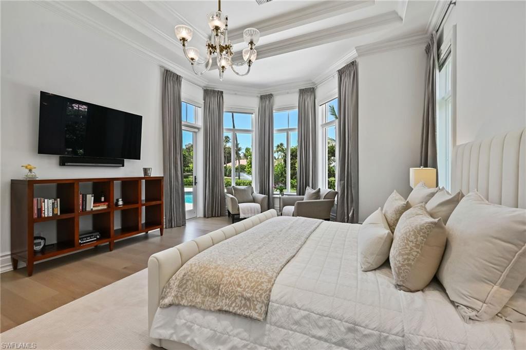 333 Sedgwick Court Naples, FL 34108 - Photo 32 of 49 a bedroom with a bed a flat screen tv and a window