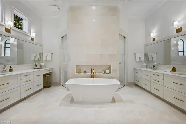 a bathroom with a double vanity sink mirror and bathtub