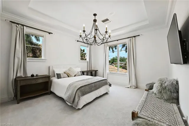 a bedroom with a bed flat screen tv and a window