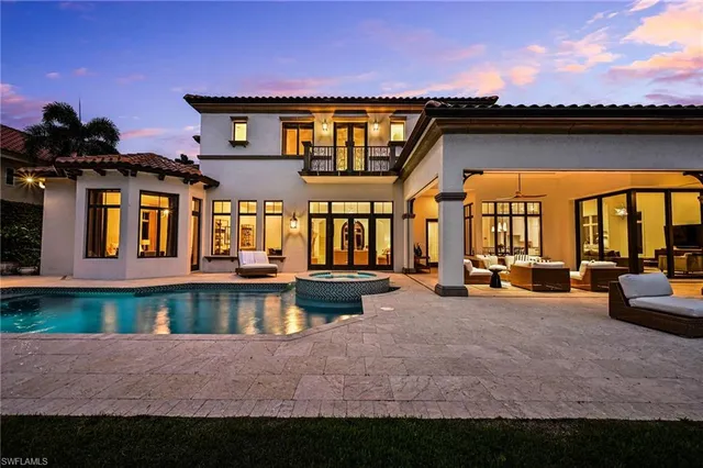 a view of a house with swimming pool and sitting area