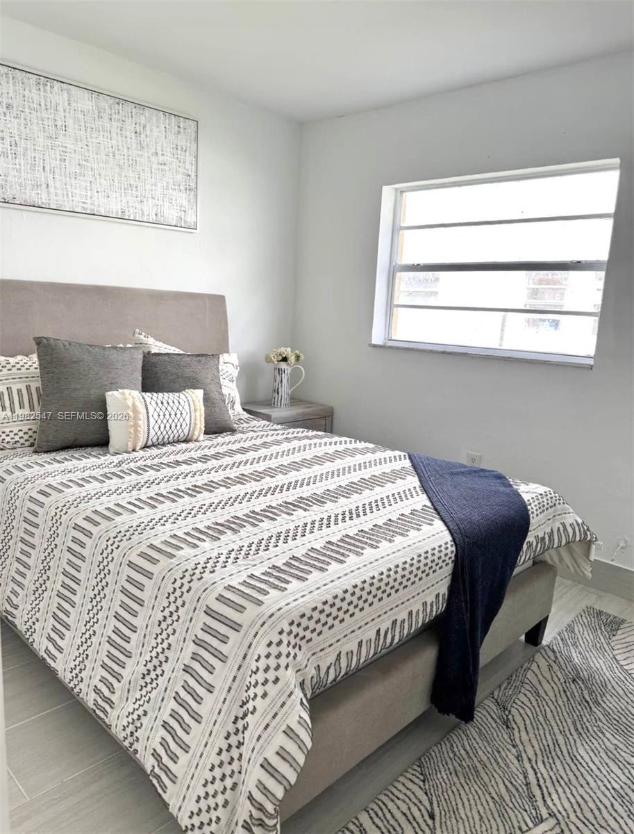 975 West 74th Street, Unit 301 Hialeah, FL 33014 - Photo 2 of 3 a bedroom with a bed and a window
