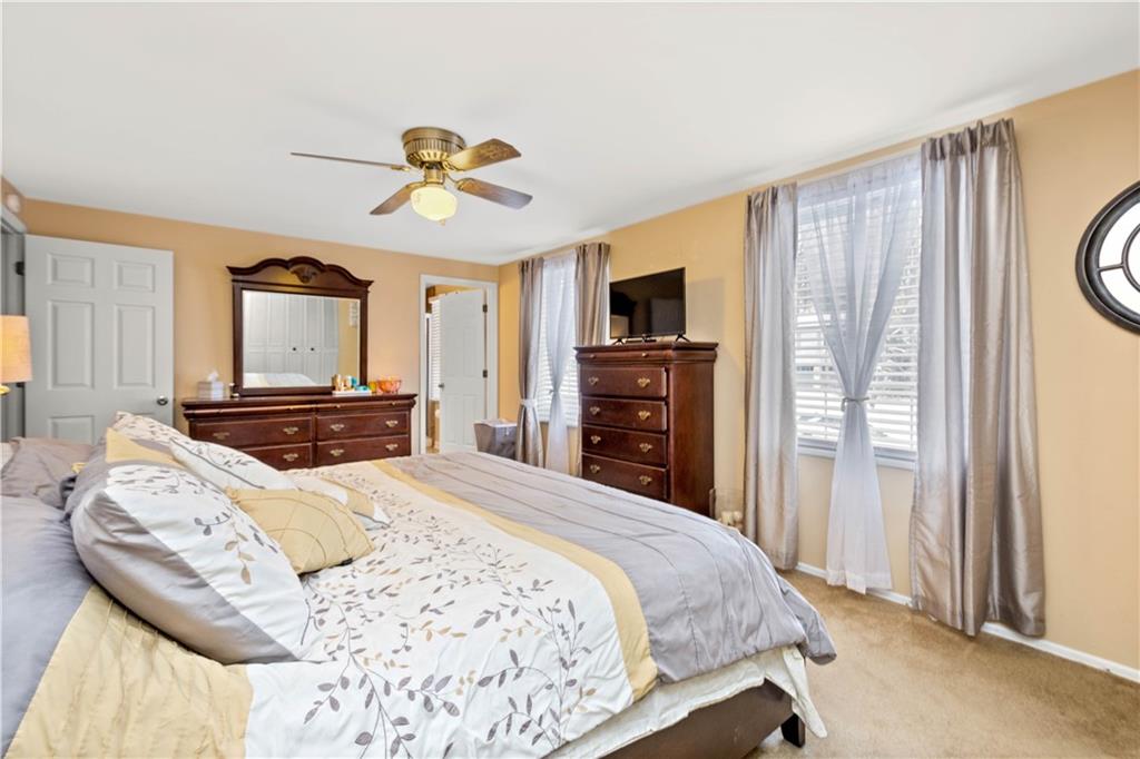 2143 Pendleton Drive Monroeville, PA 15146 - Photo 11 of 25 a bedroom with a bed a dresser and a chandelier