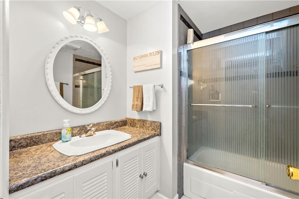 2143 Pendleton Drive Monroeville, PA 15146 - Photo 14 of 25 a bathroom with a granite countertop sink a mirror and a bathtub