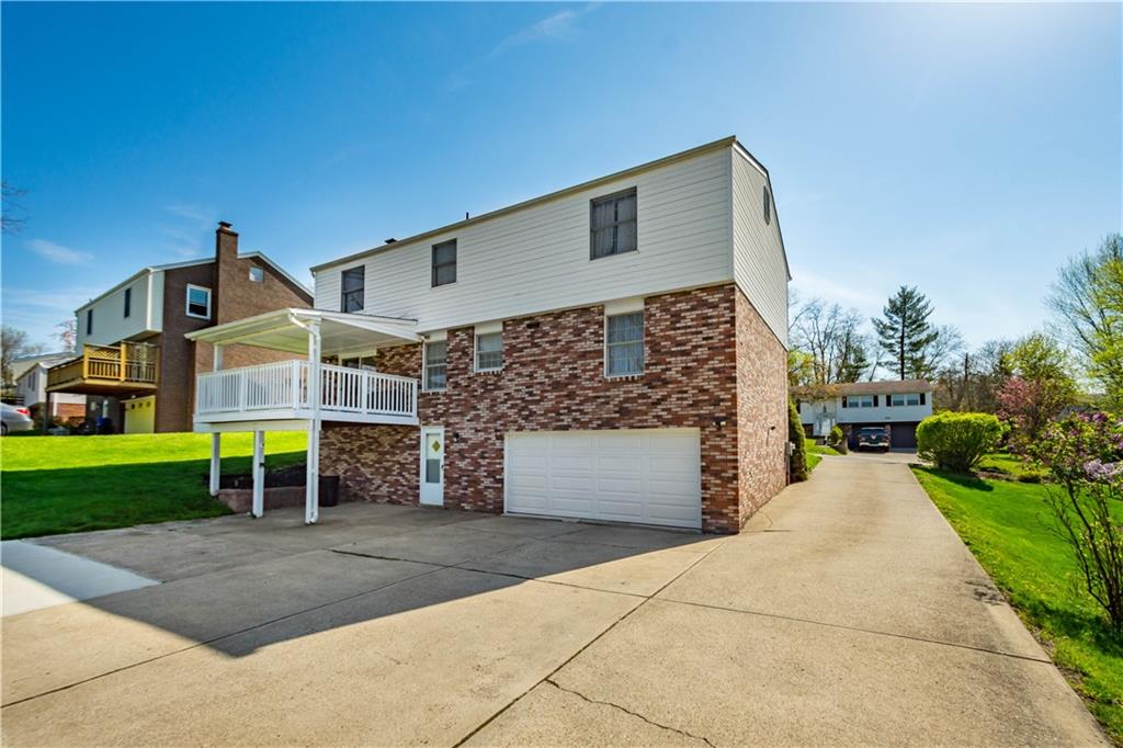 2143 Pendleton Drive Monroeville, PA 15146 - Photo 21 of 25 a front view of a house with a yard and garage