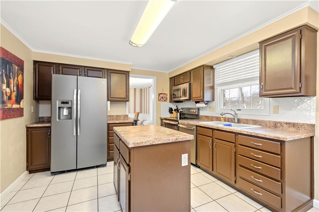 2143 Pendleton Drive Monroeville, PA 15146 - Photo 8 of 25 a kitchen with a refrigerator sink and cabinets